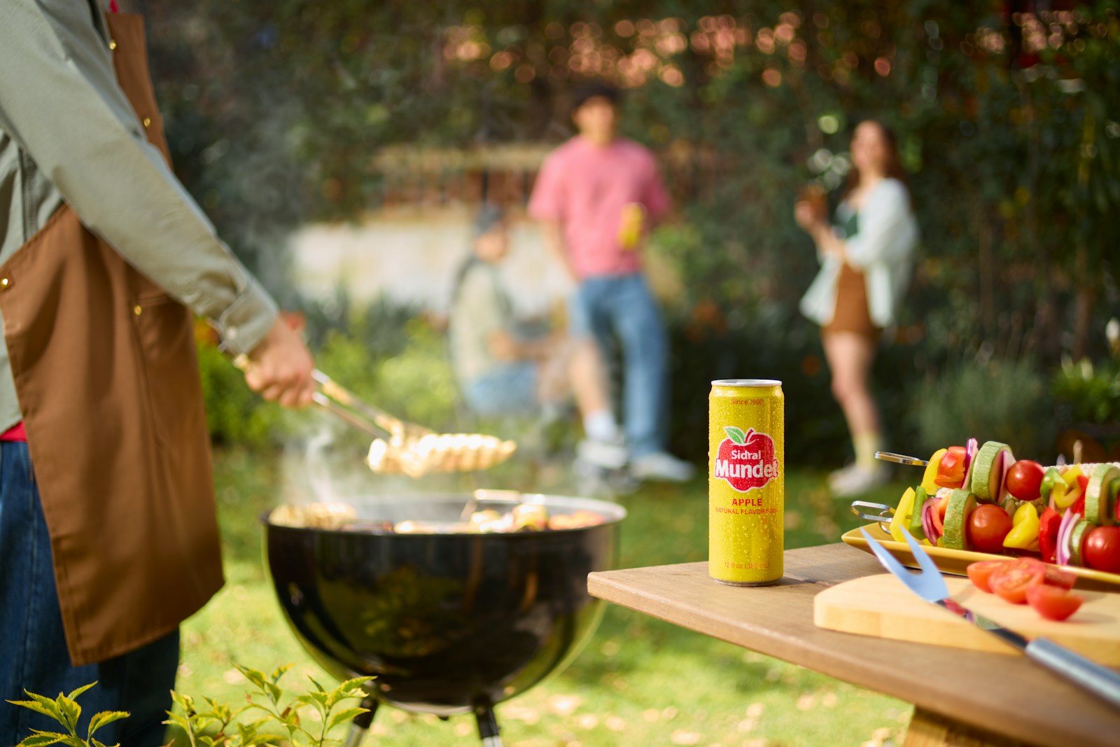Friends enjoy a backyard barbecue and drinks.