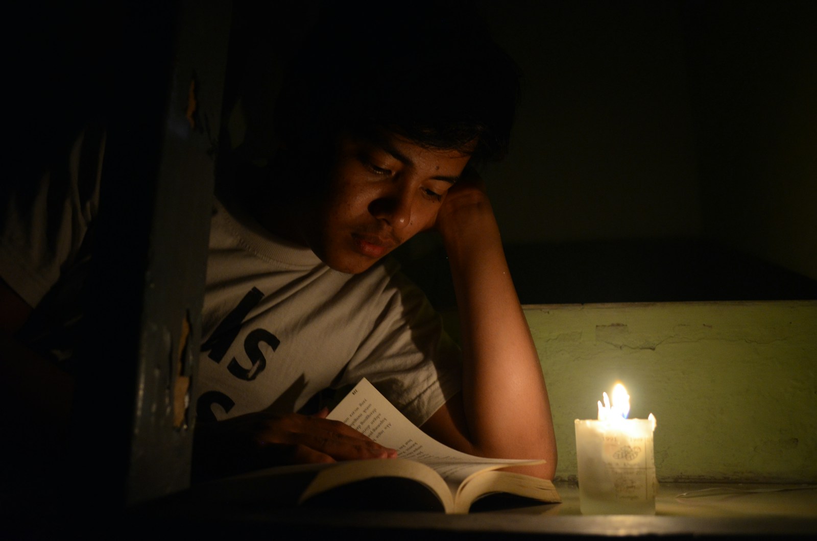 woman in white crew neck t-shirt holding white book