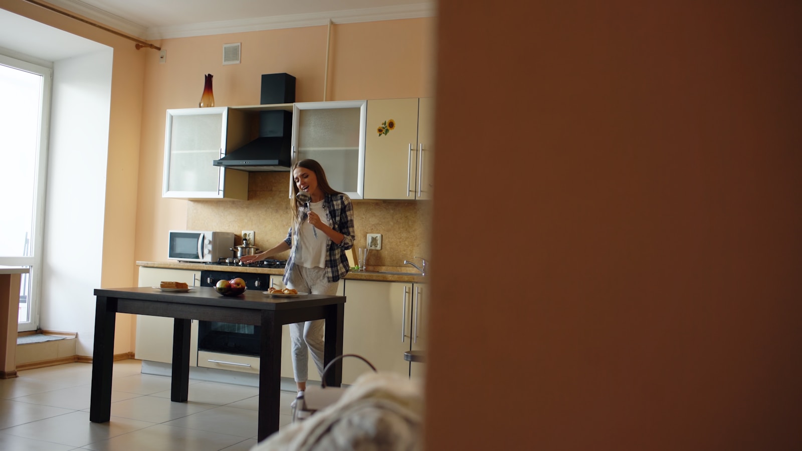 Woman talking on phone in a kitchen
