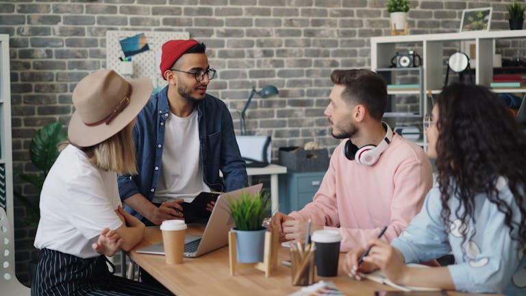 Young creative team discussing project ideas in a modern office setting.