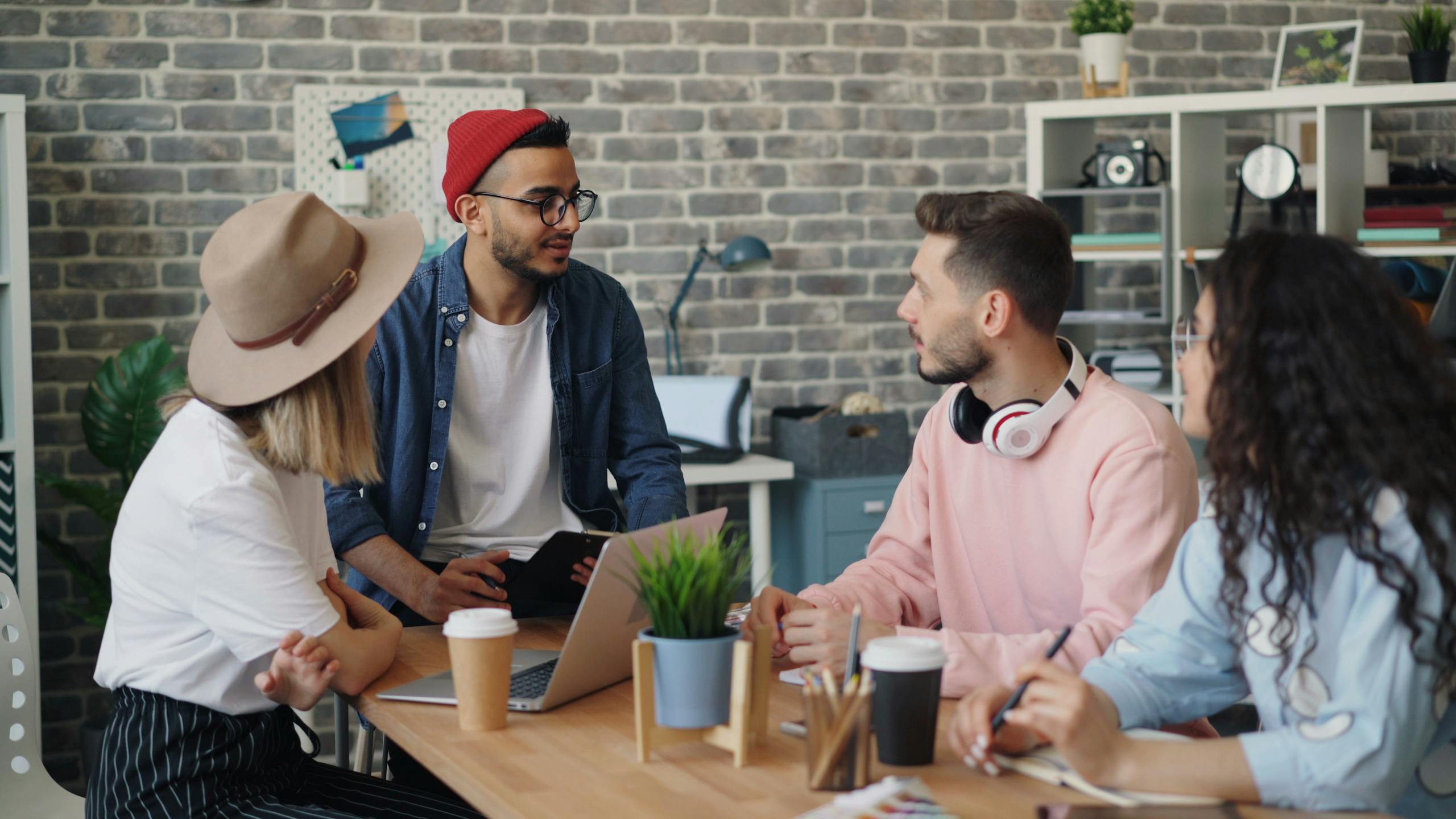 Young creative team discussing project ideas in a modern office setting.