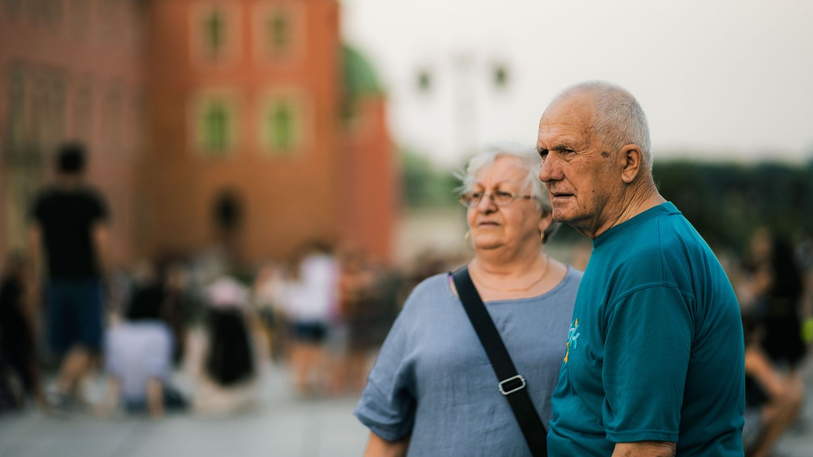 Senior couple enjoying a day out in a bustling city setting.