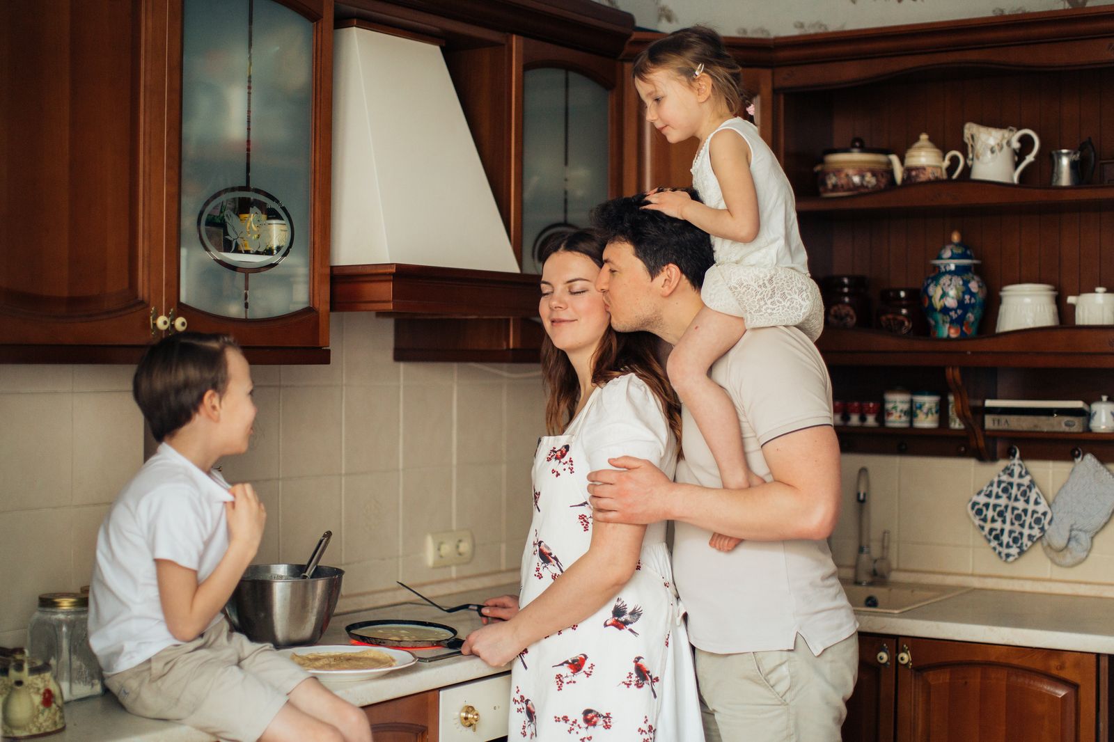 A joyful family enjoying cooking and spending quality time together in the kitchen.