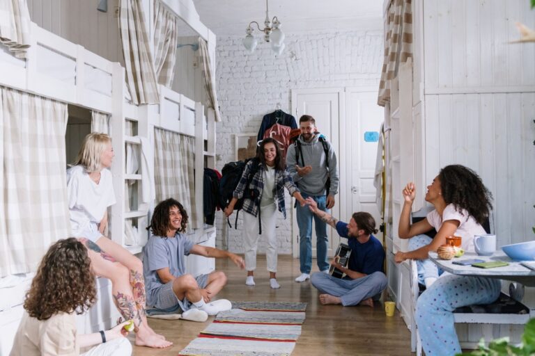 A diverse group of friends enjoying each other's company in a cozy dorm room, creating a warm and vibrant atmosphere.