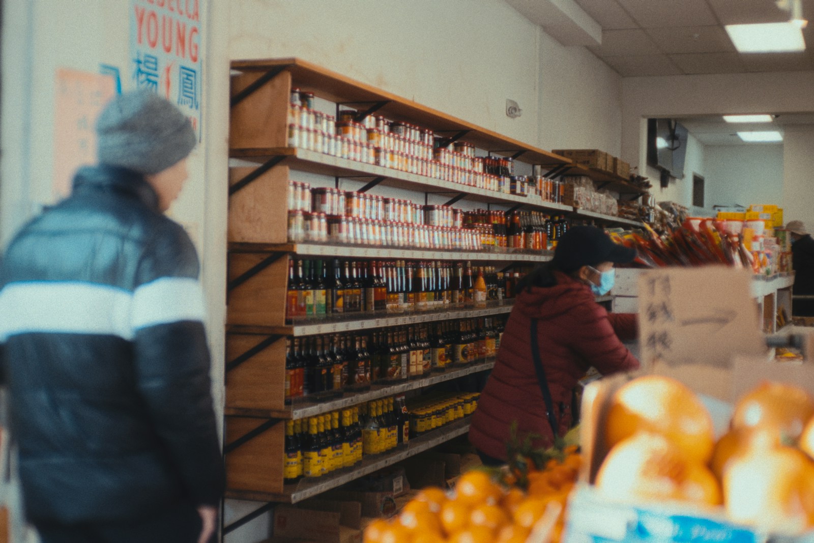 a person in a store looking at a shelf of food