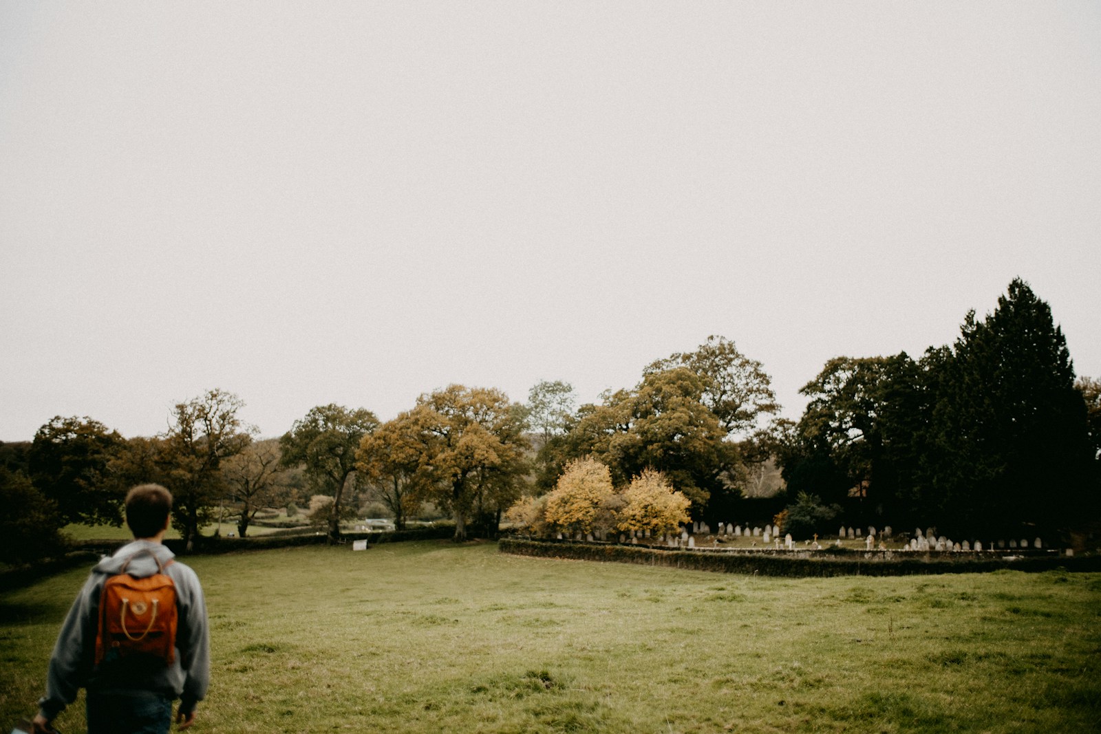 a man standing on top of a grass covered field