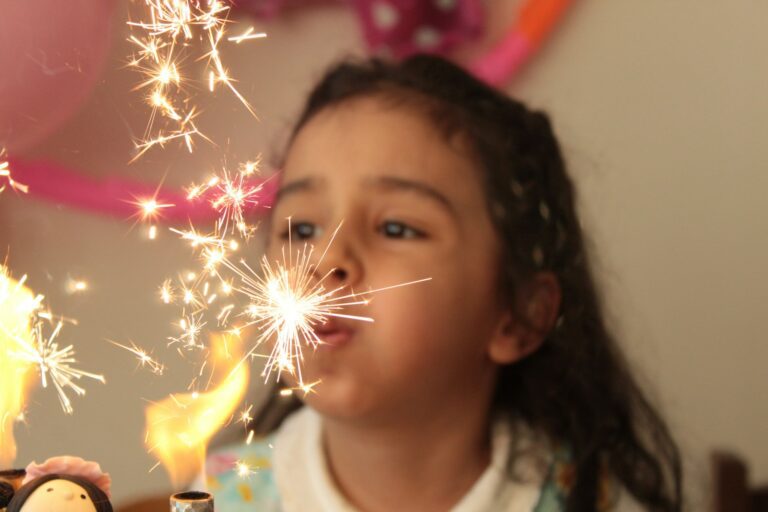 girl in white shirt with yellow and red string lights