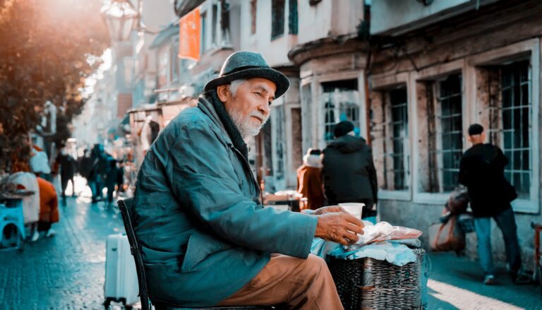 a man sitting on a chair in the middle of a street