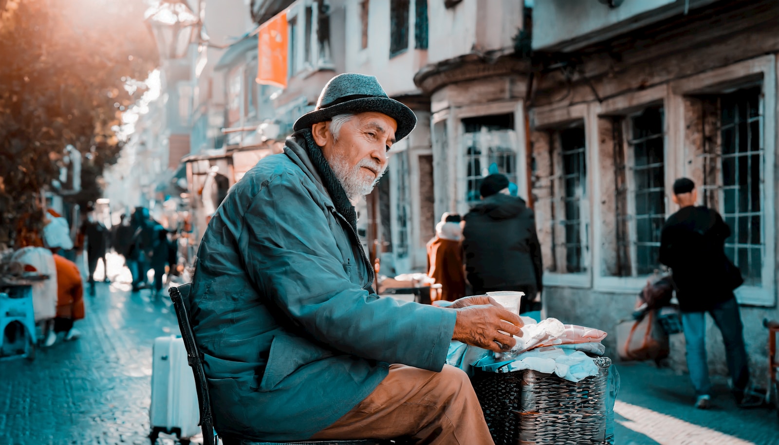 a man sitting on a chair in the middle of a street