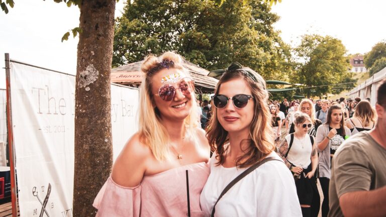 two woman standing near people