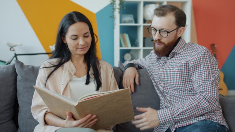 Couple looking at an open photo album together
