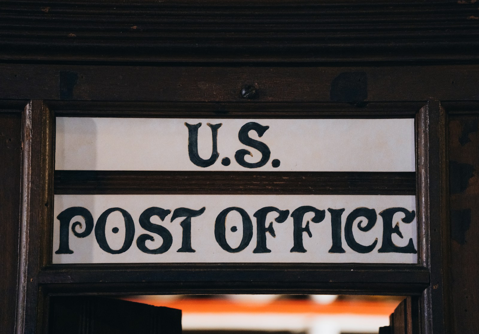 U.s. post office sign on a wooden door