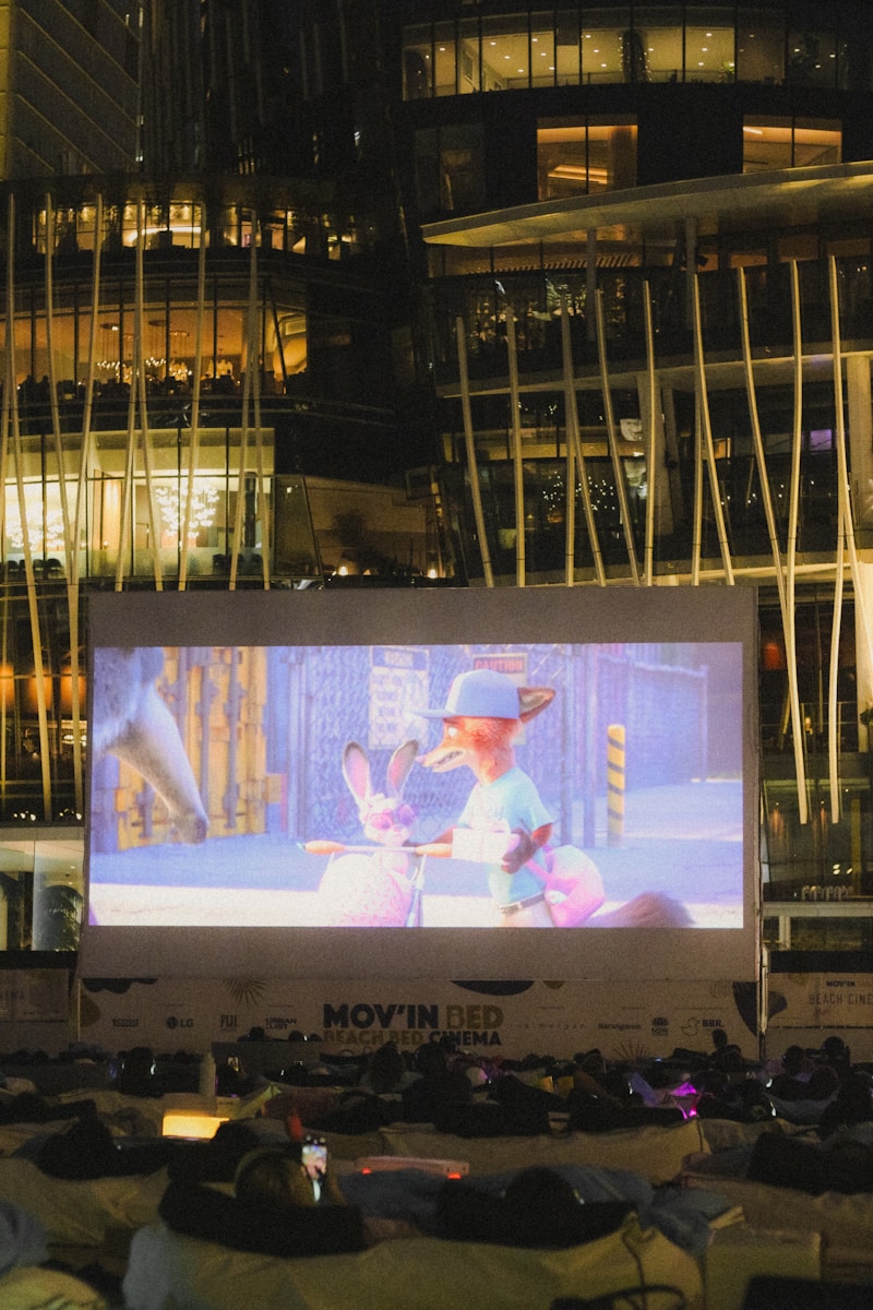 Outdoor movie screen with audience at night