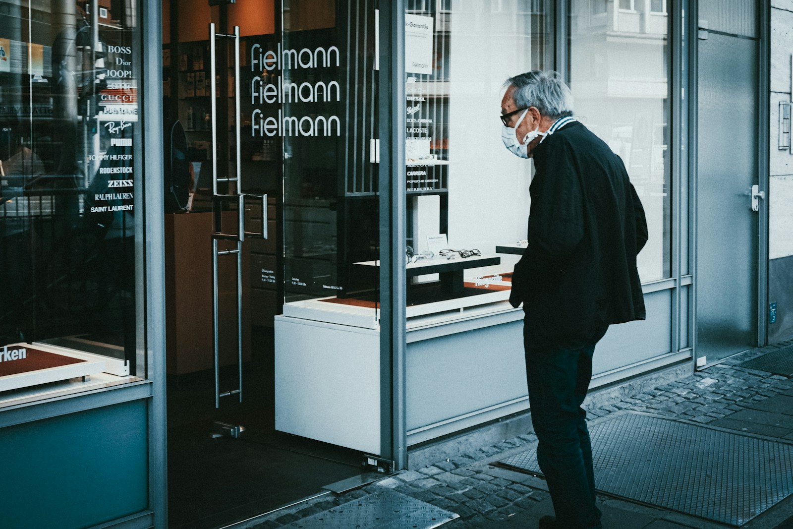 a man standing in front of a store window