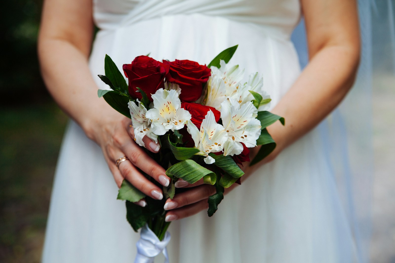 Bride holds a bouquet of flowers.
