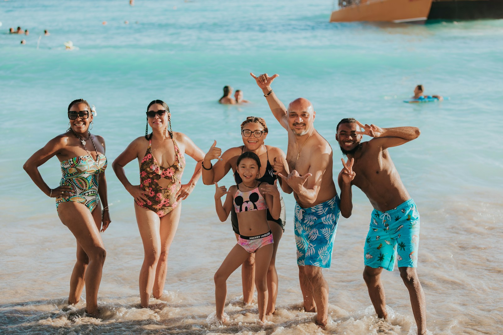 a group of people posing for a photo on a beach