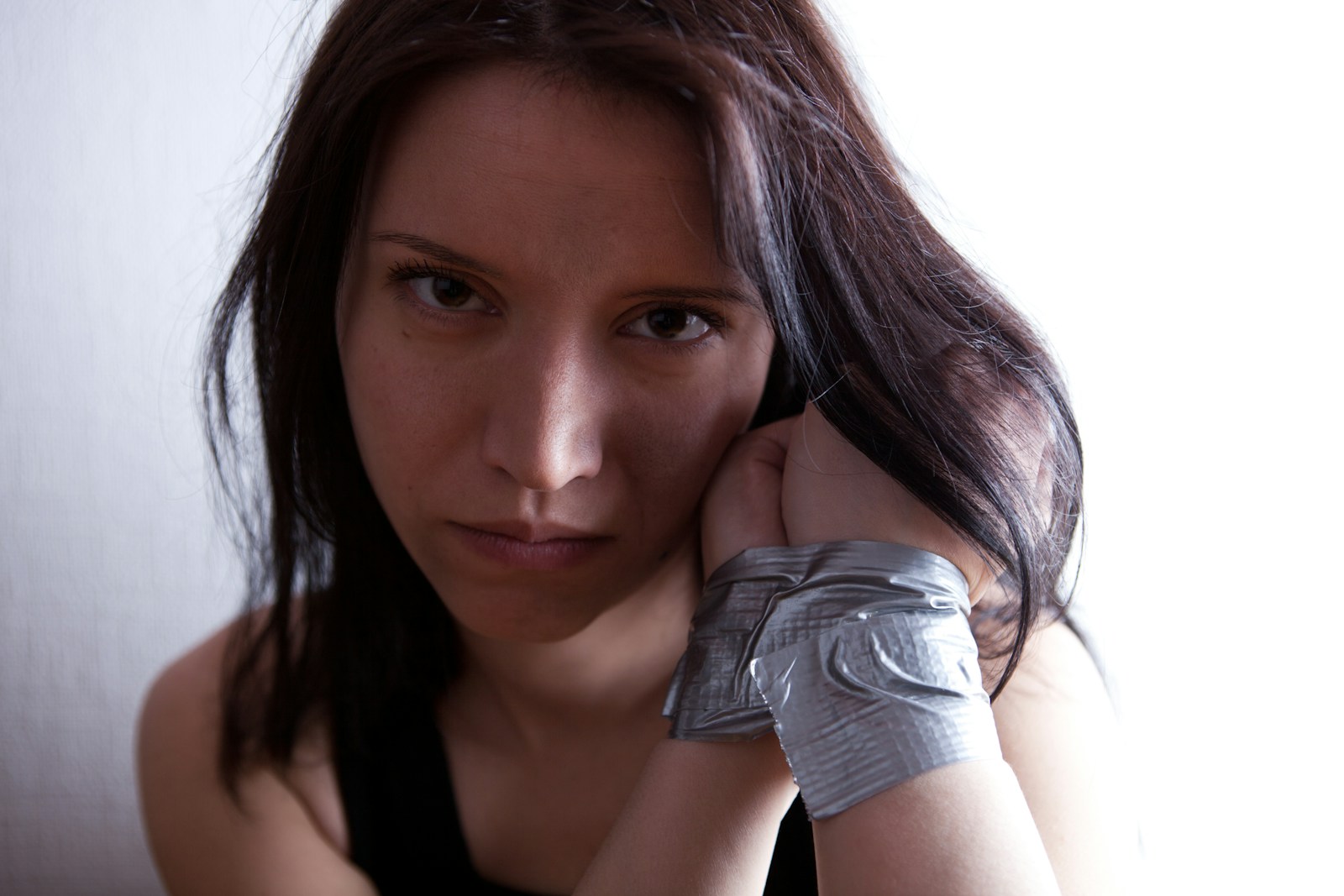 A woman holding her hand up to her face