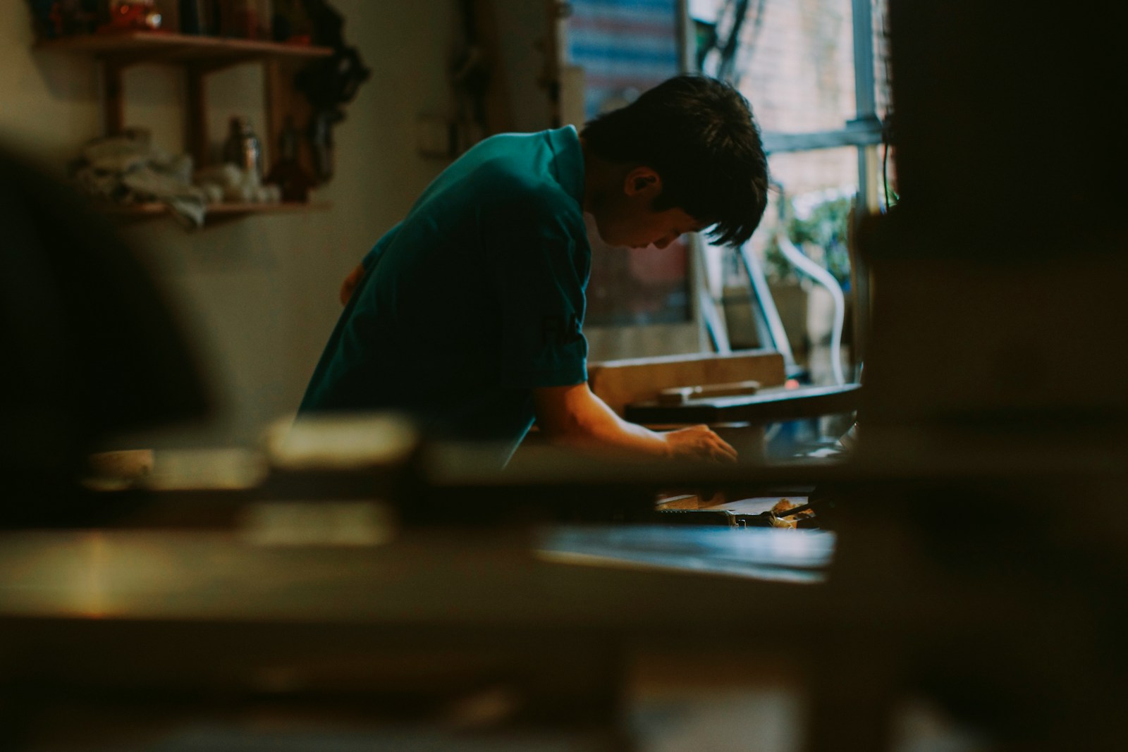 Young person concentrating on a task indoors.
