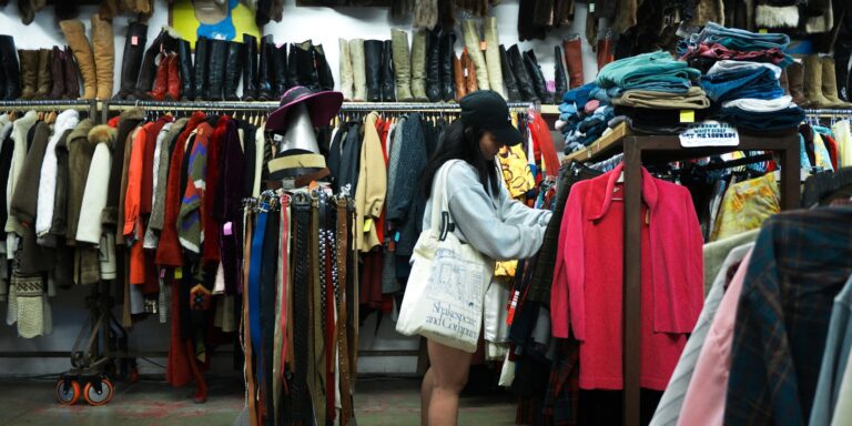 Woman browsing clothes at a thrift store.