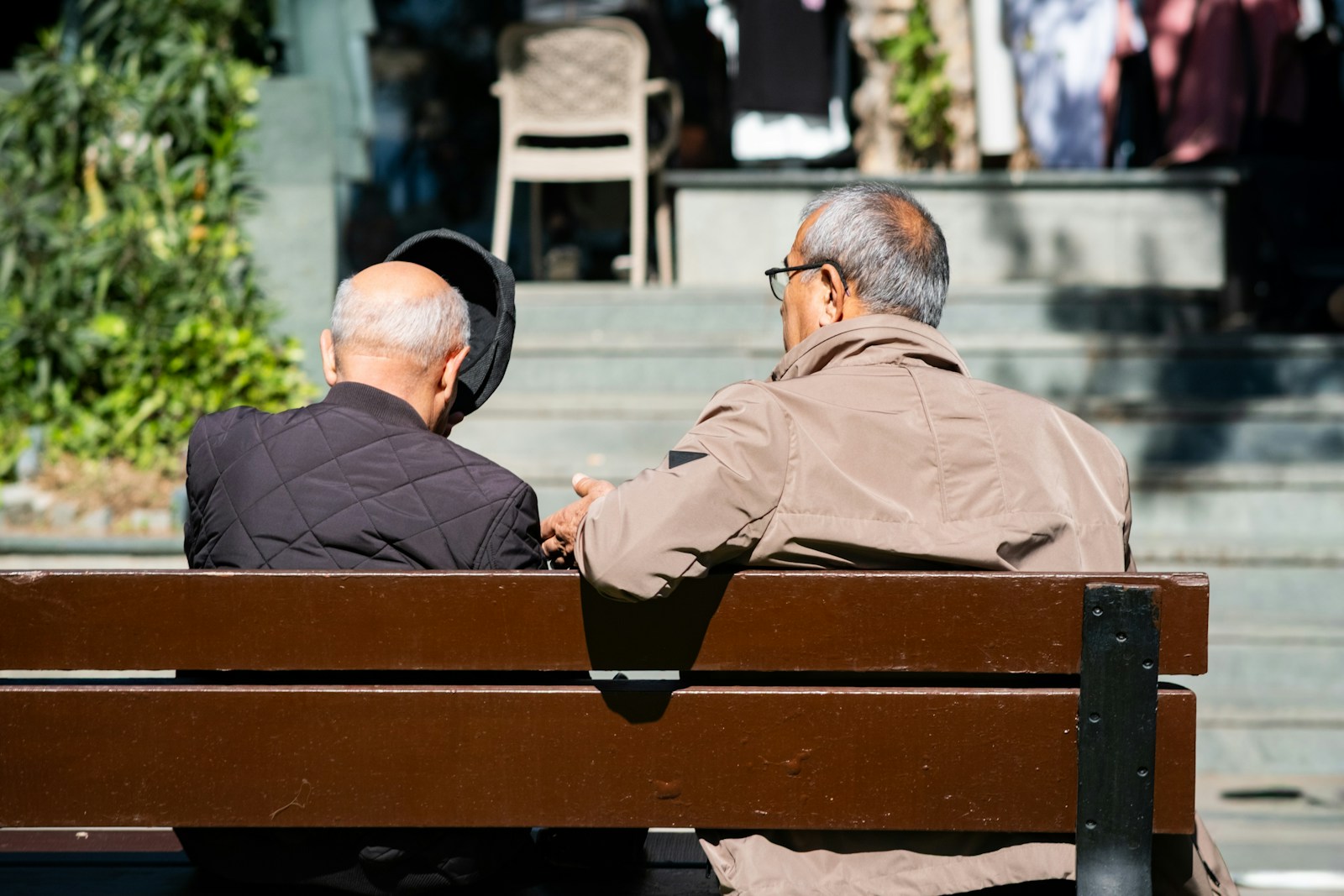 Two elderly men sitting on a park bench
