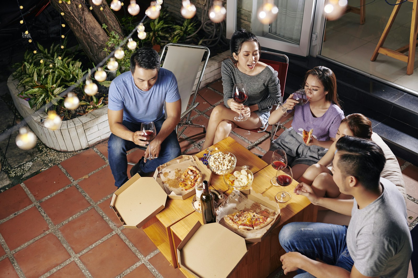 a group of people sitting around a table with food
