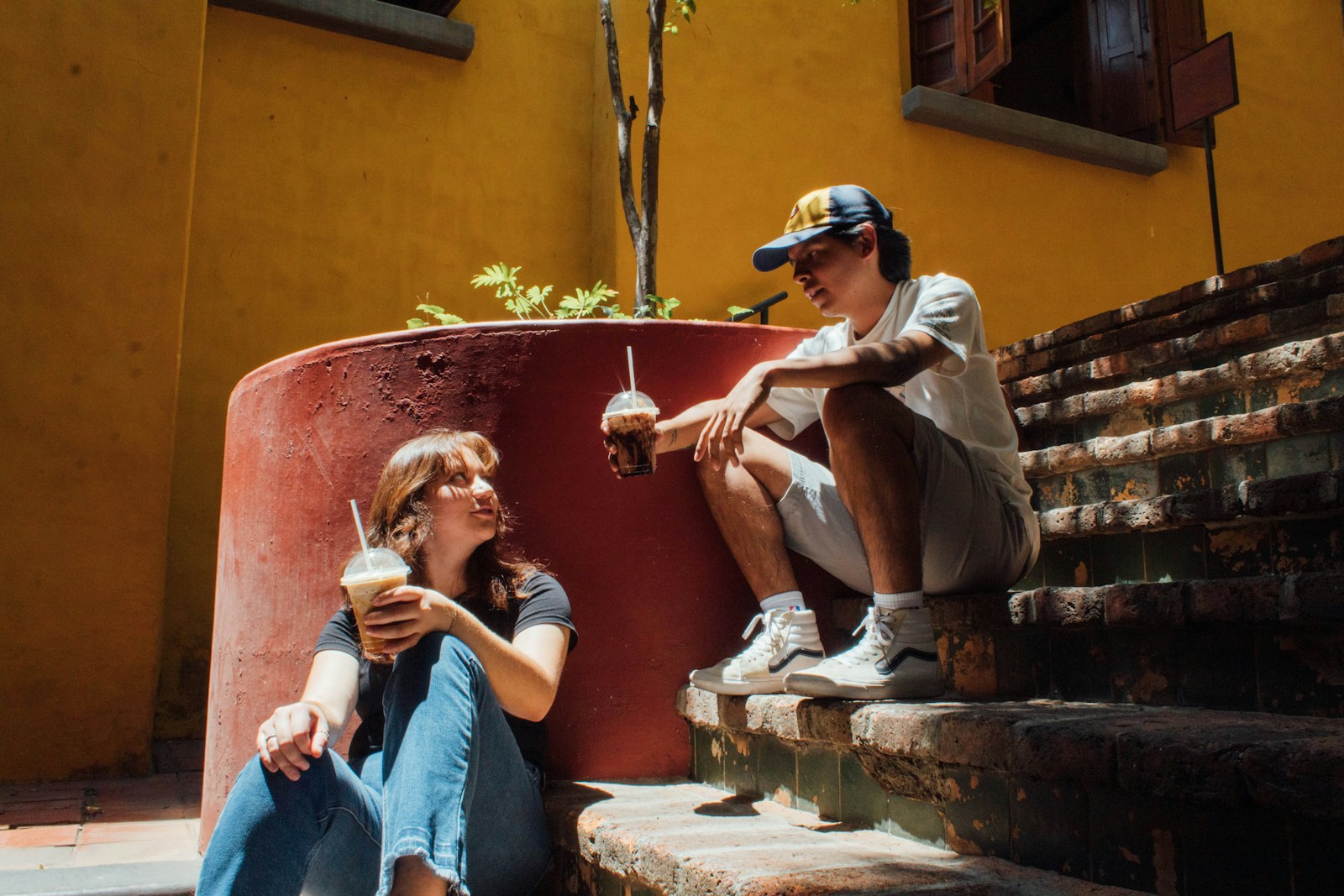 a man and a woman sitting on the steps of a building
