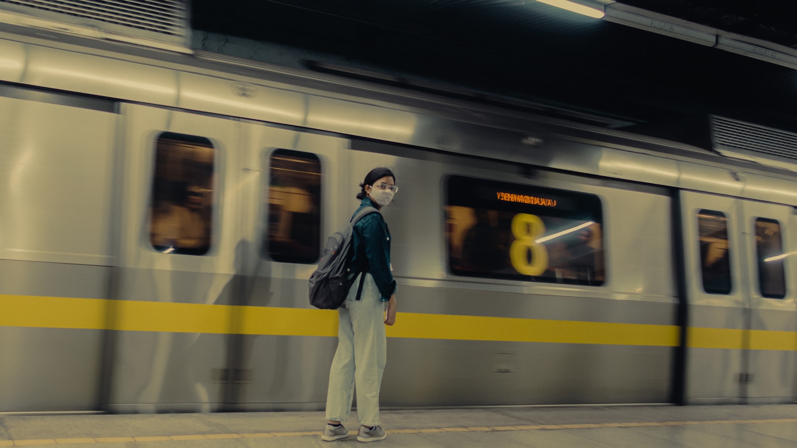 a person standing in front of a train