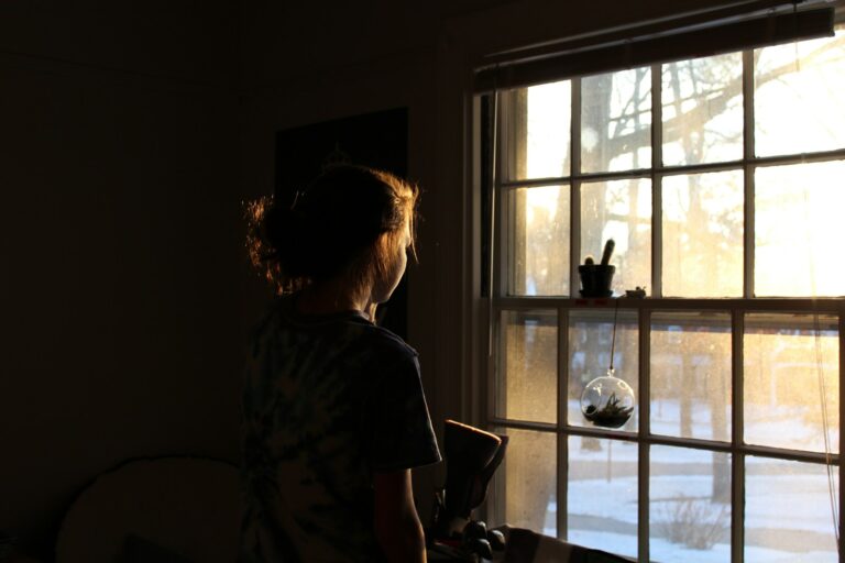 woman in room facing window