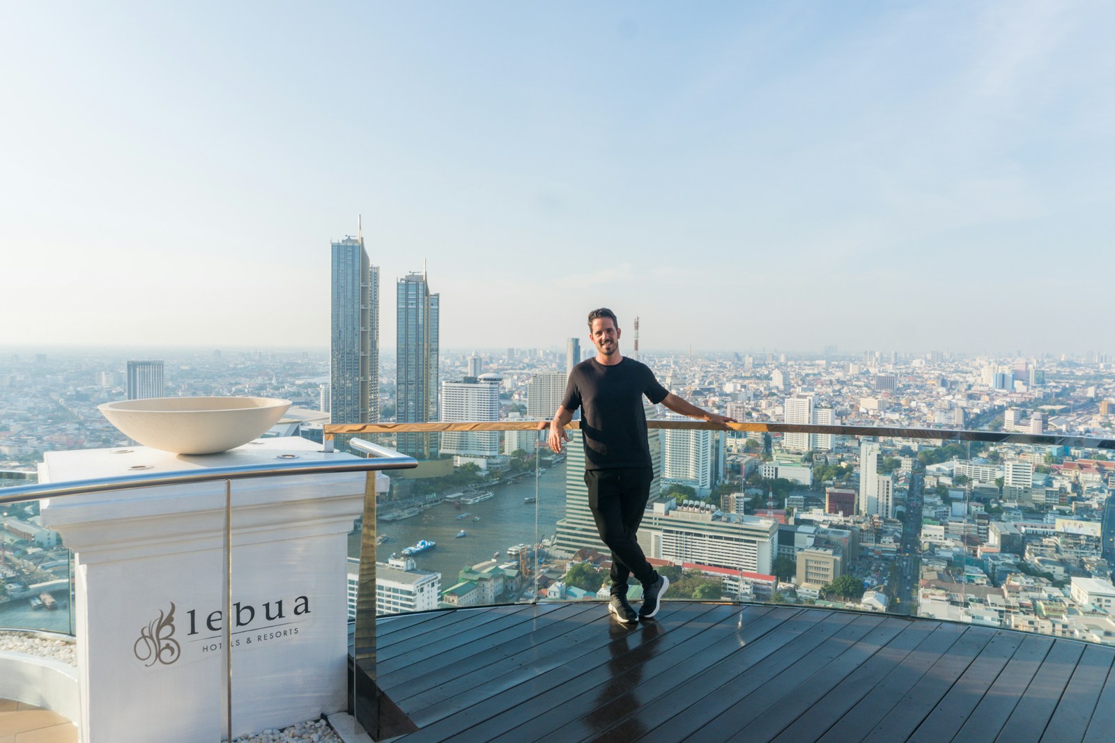 A man standing on top of a tall building