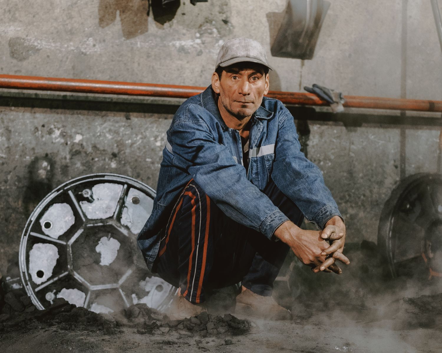Portrait of a mechanic in an industrial workshop with tools and machinery.
