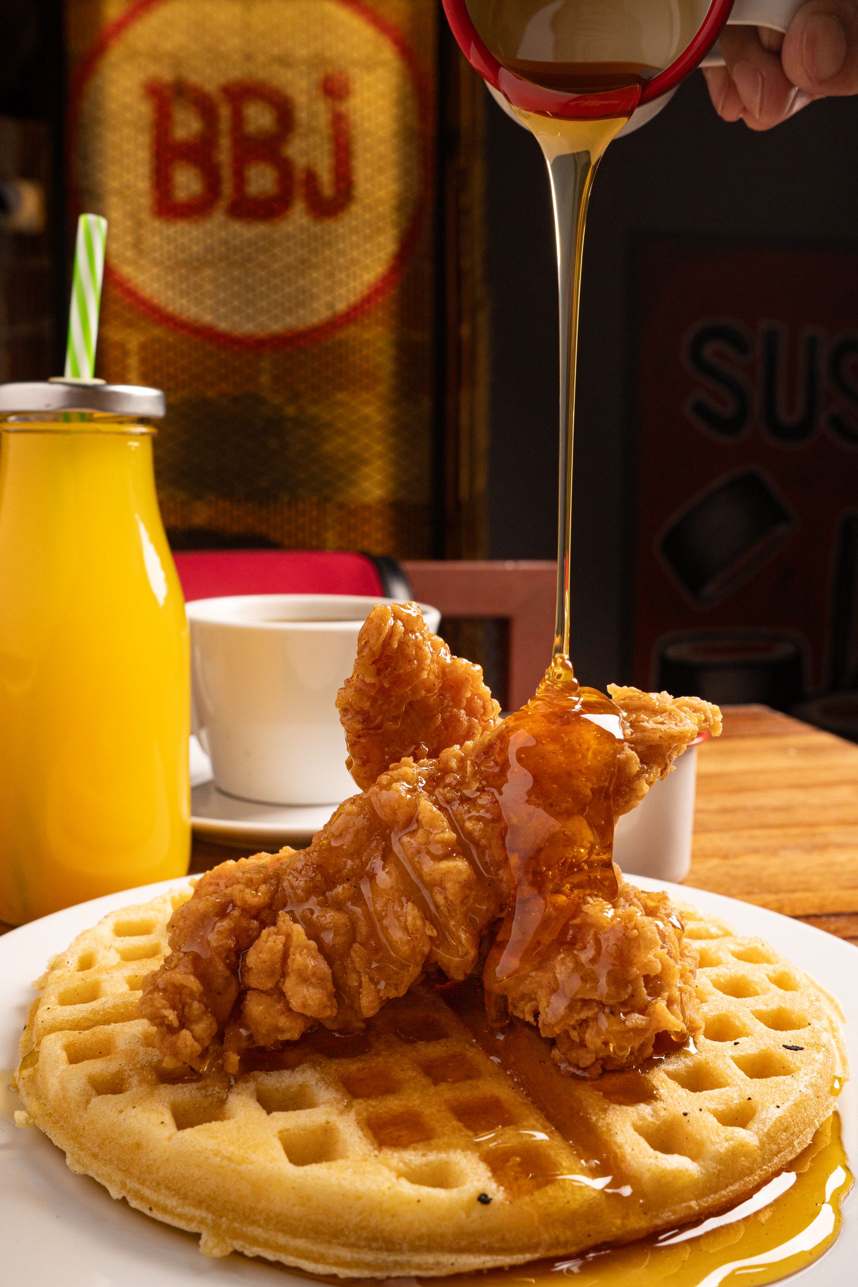 Delicious chicken and waffles drizzled with maple syrup, perfect for breakfast or brunch.