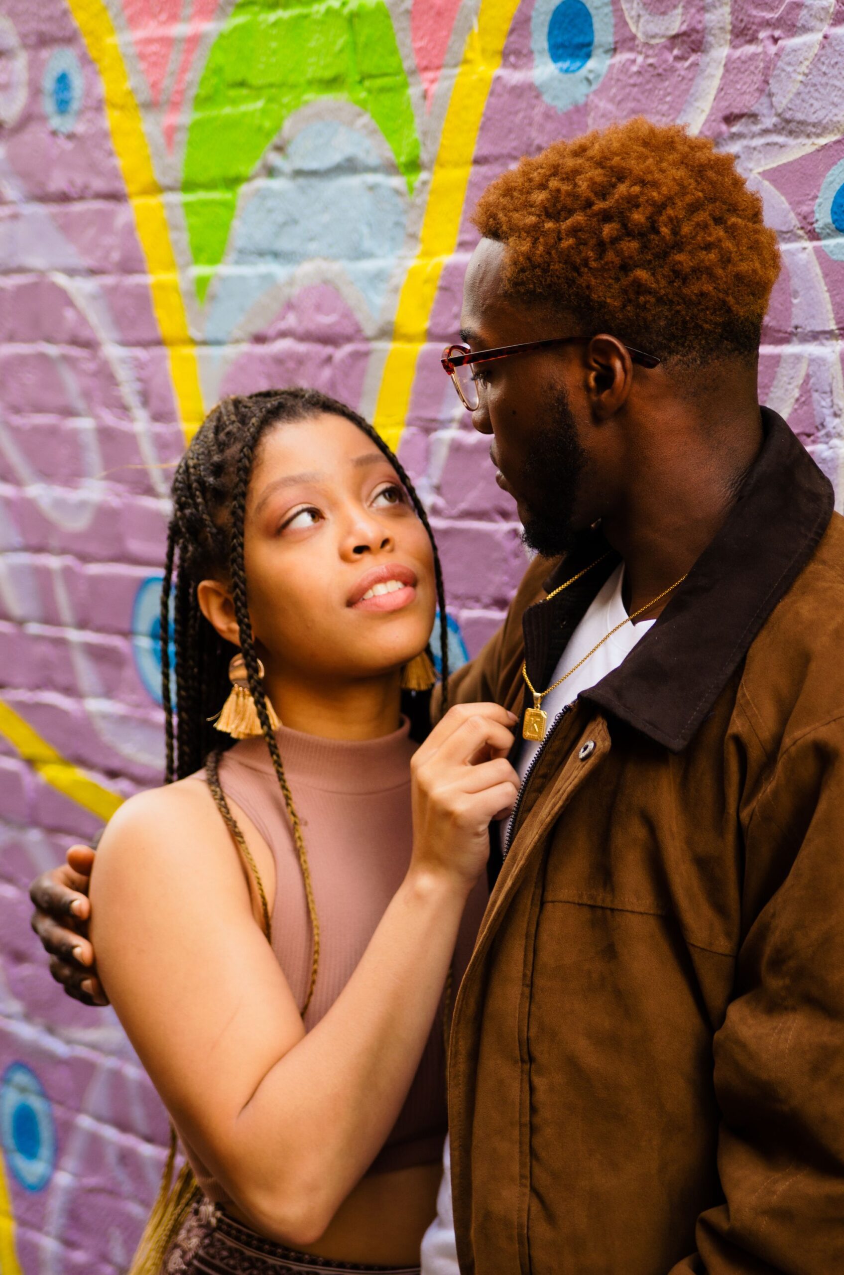 Two young adults making direct eye contact outdoors, sharing an open and emotionally connected conversation