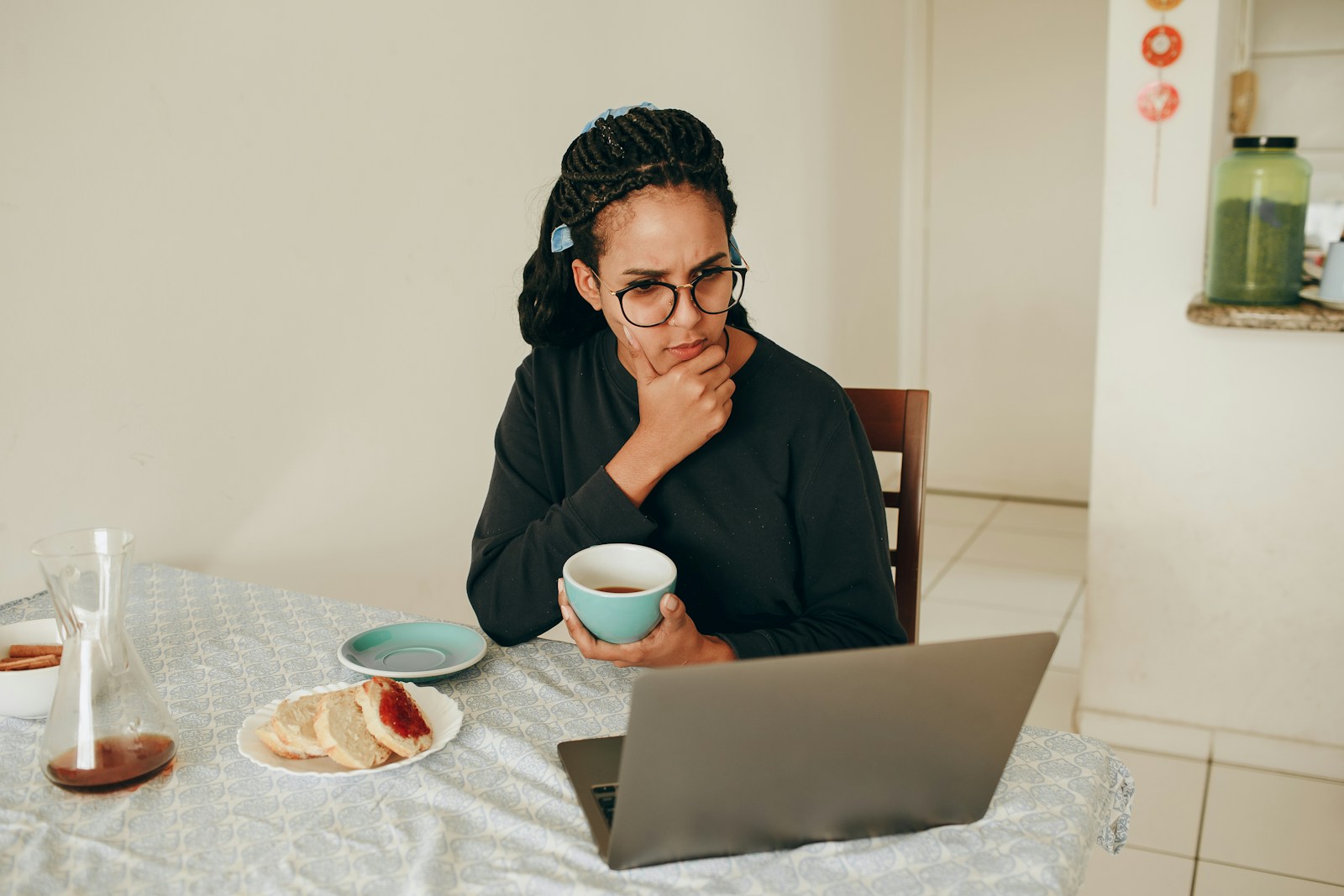 woman in black long sleeve shirt wearing black framed eyeglasses