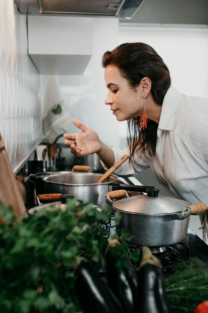 woman in white robe holding chopsticks