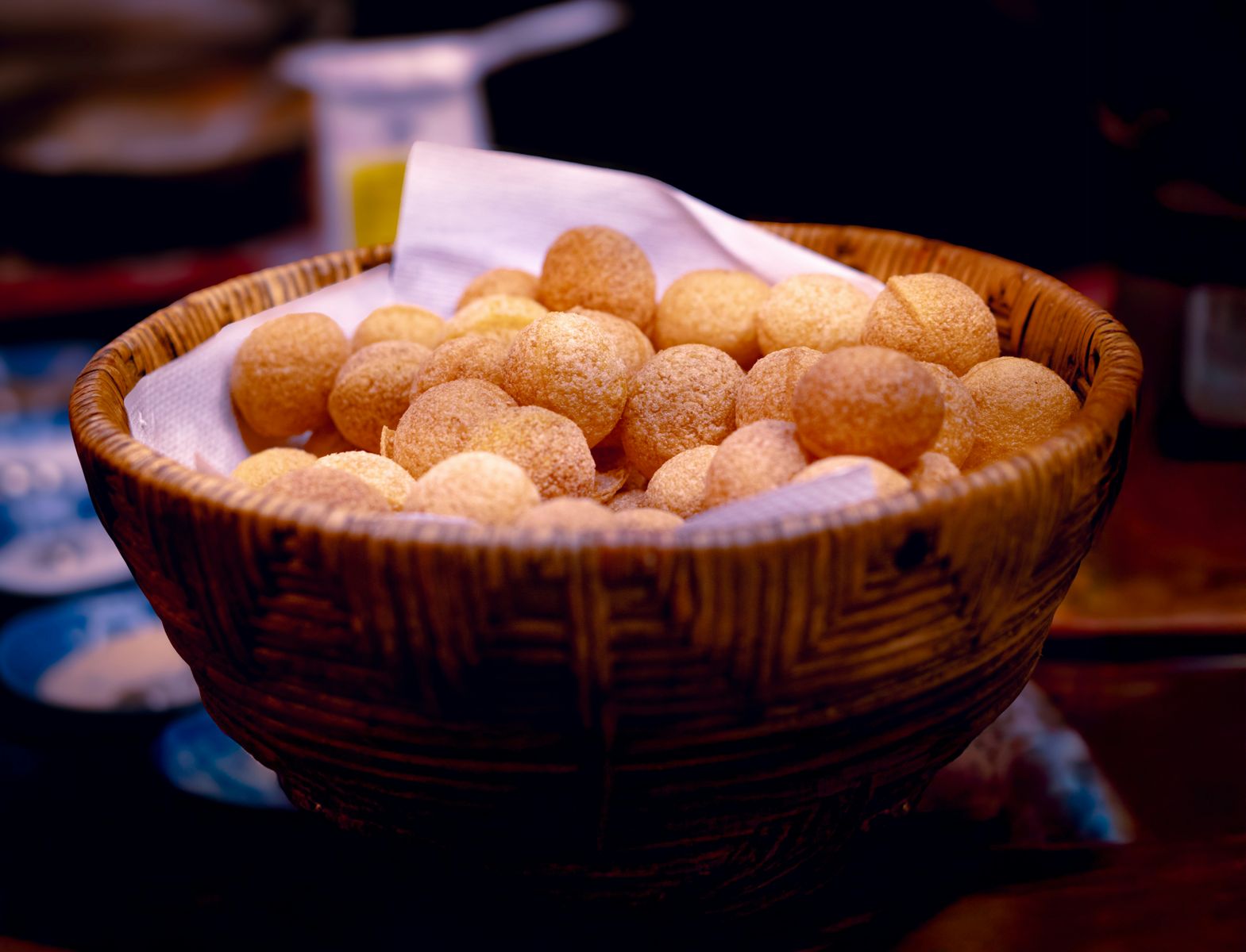 A basket of crispy Indian pani puri ready to serve, highlighting authentic street food.