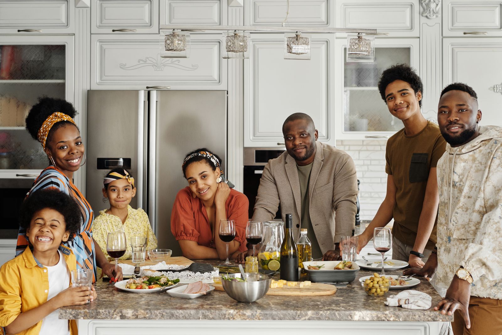 Family enjoying a meal together in a bright kitchen, sharing smiles and laughter.