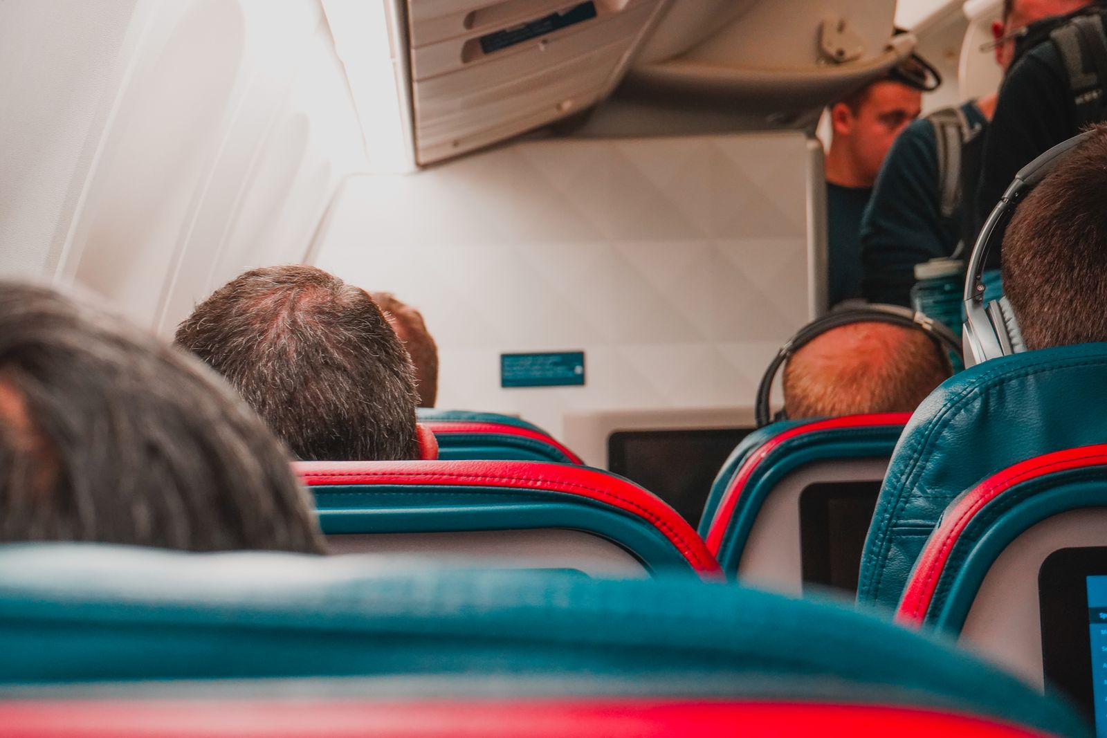 Interior view of an airplane cabin with passengers seated, focusing on seats and layout.