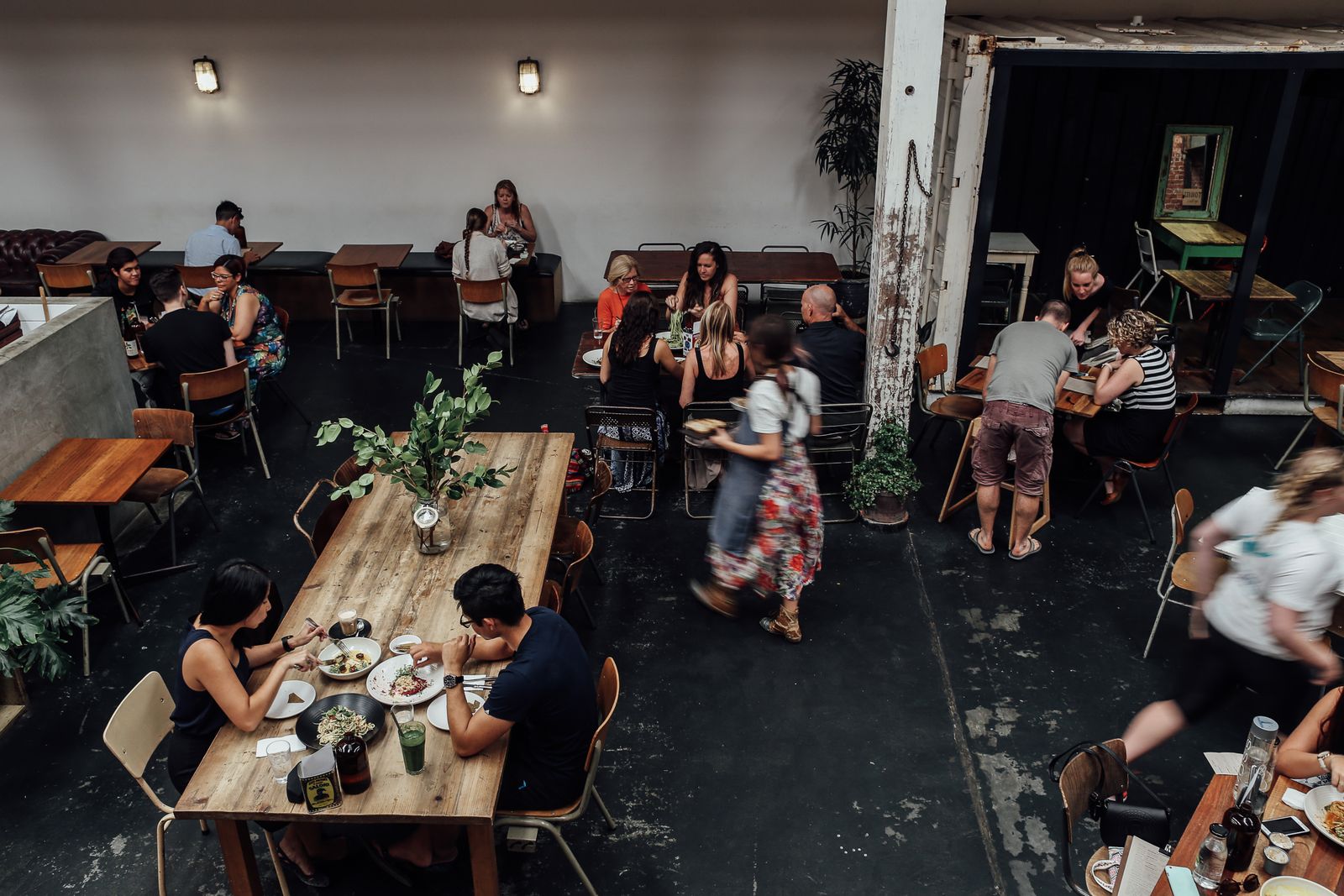 Indoor view of a busy restaurant with people enjoying meals at tables.