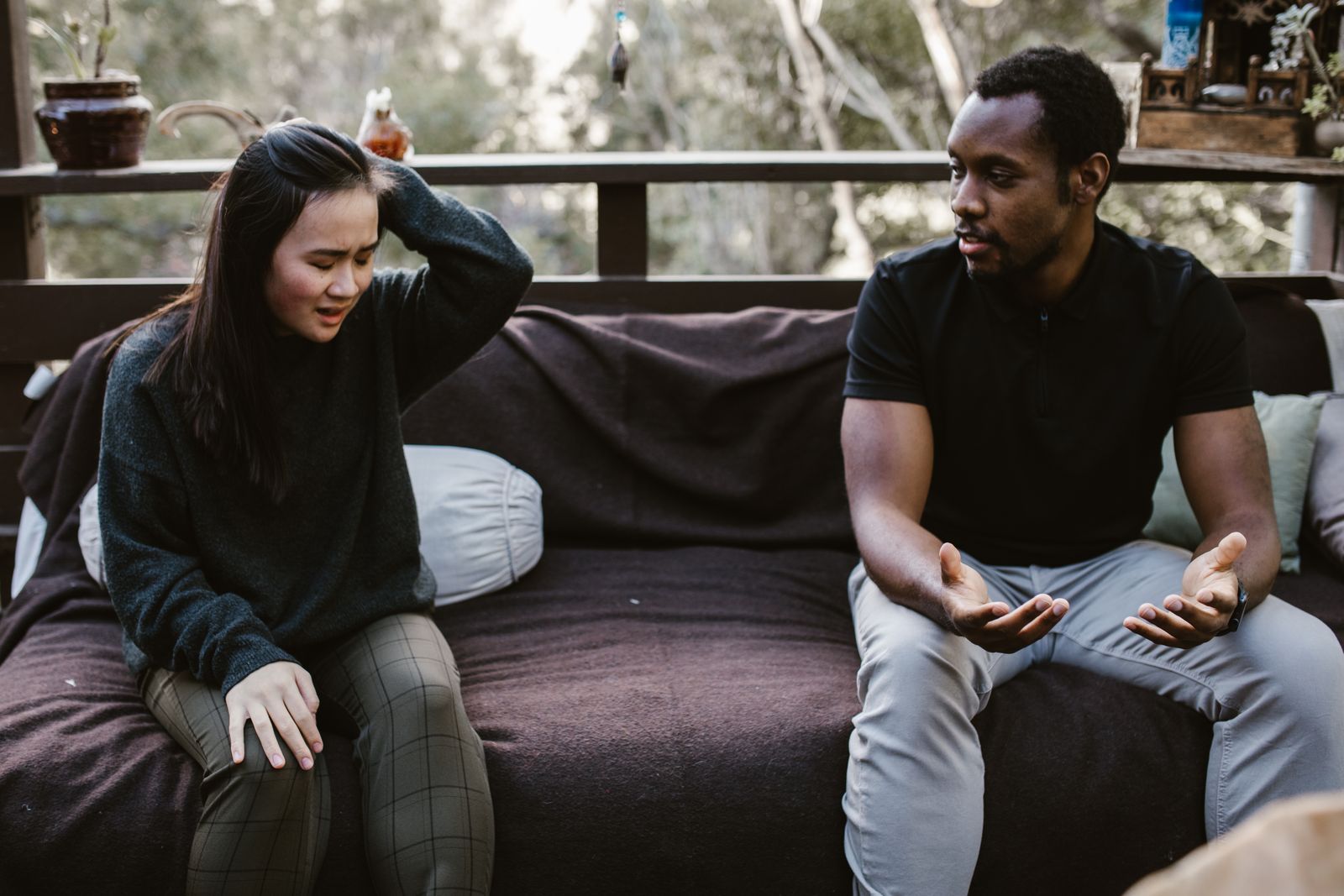 Couple having an intense discussion outdoors. Emotionally charged moment captured.
