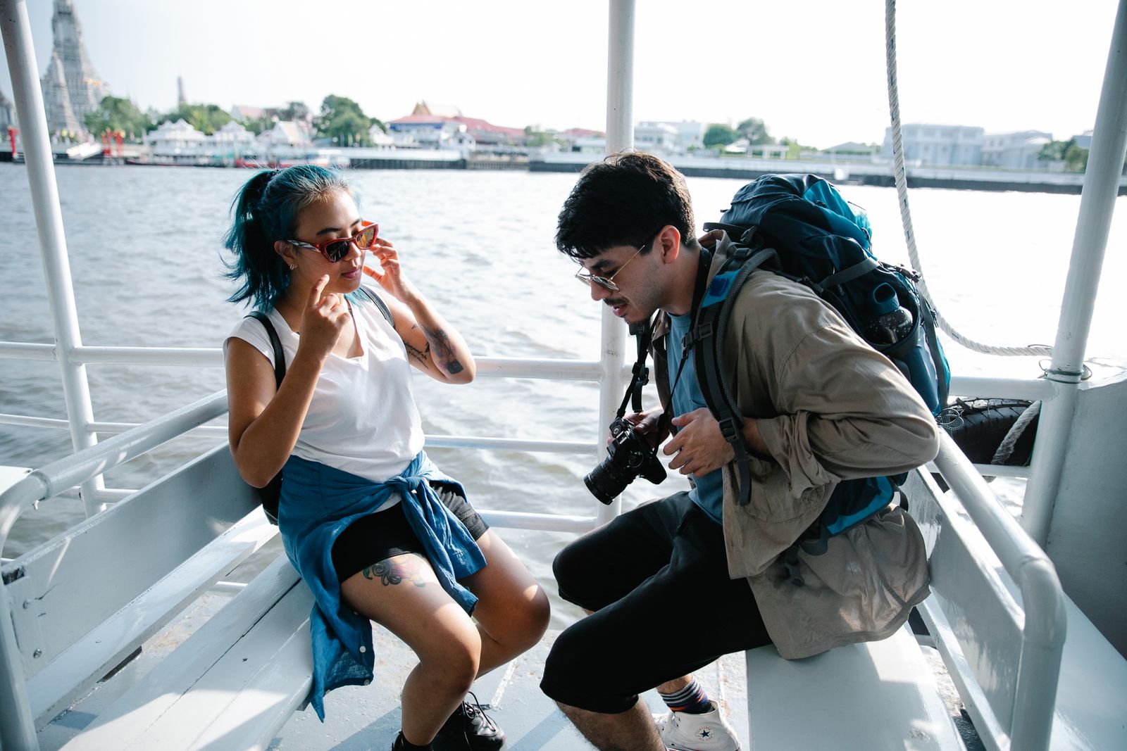 A couple enjoys a scenic ferry ride, capturing moments and relaxing by the sea.