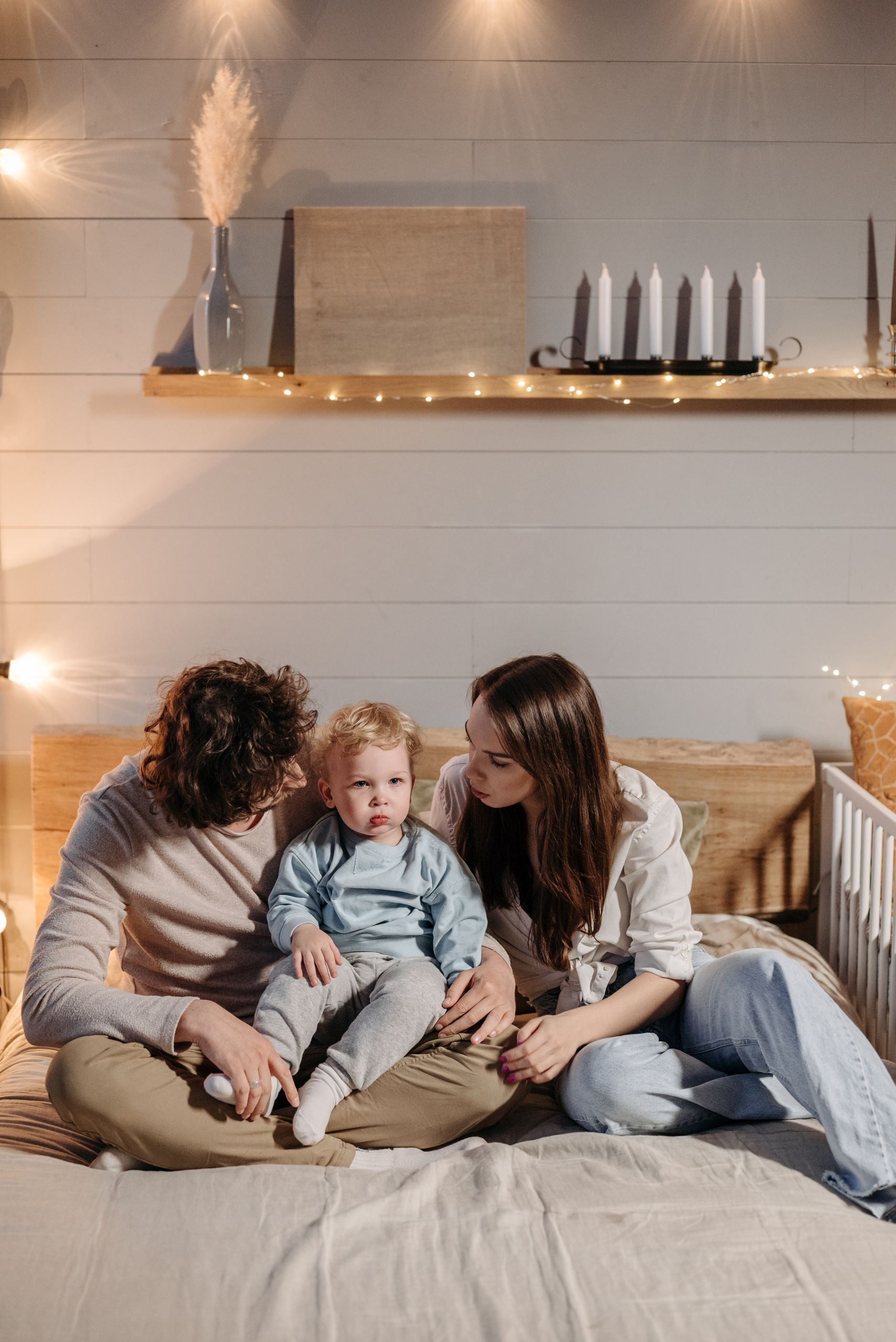 A family enjoying a warm and cozy moment together in their bedroom.