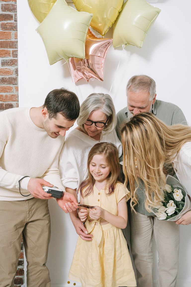 A joyful family moment with balloons and smiles captured indoors.