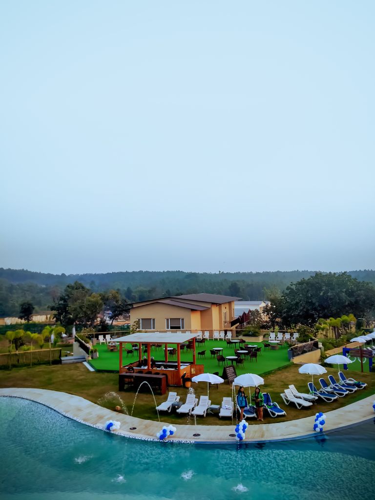 Aerial view of a luxury resort poolside during the day in Purulia, India.