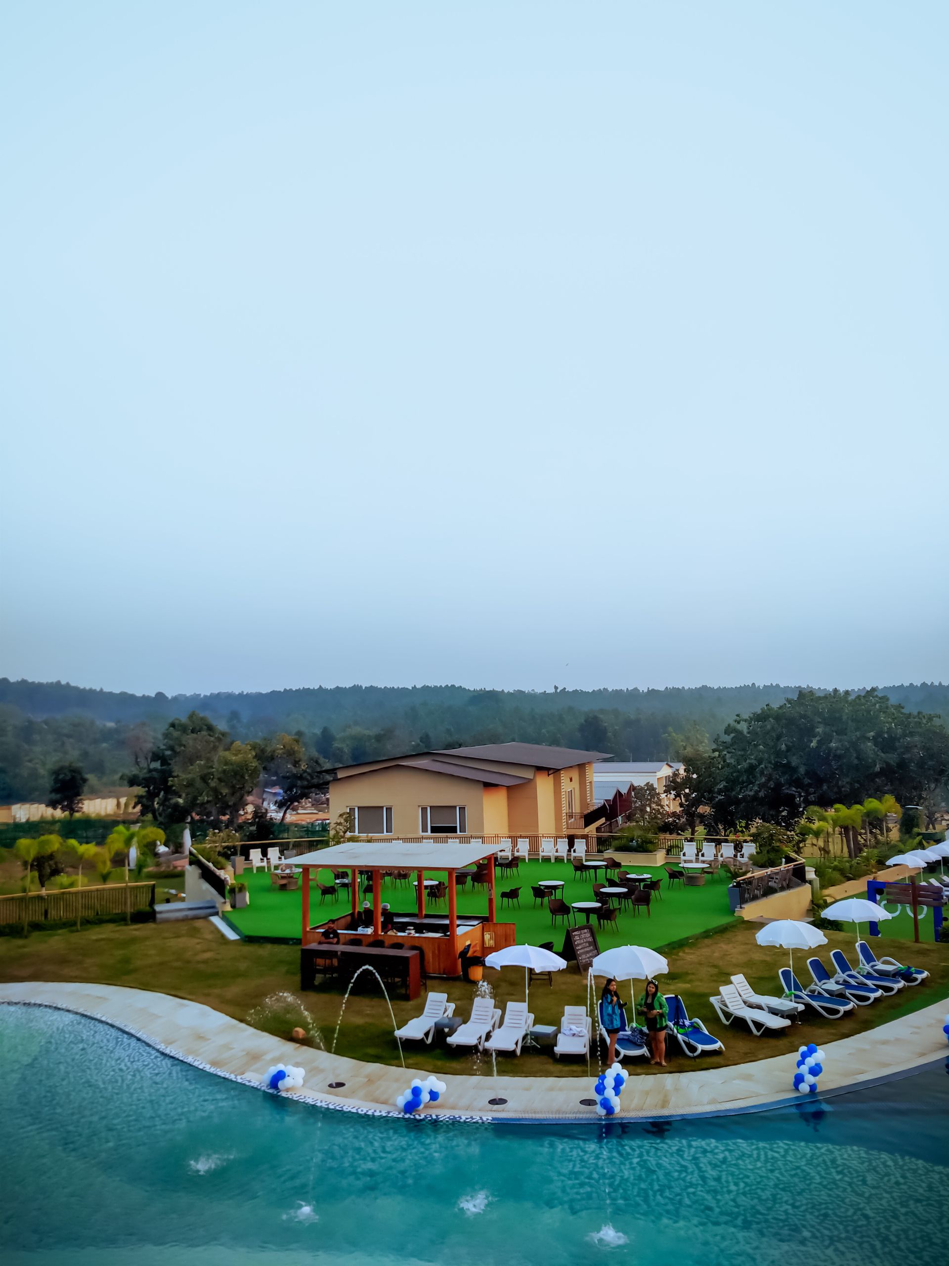 Aerial view of a luxury resort poolside during the day in Purulia, India.
