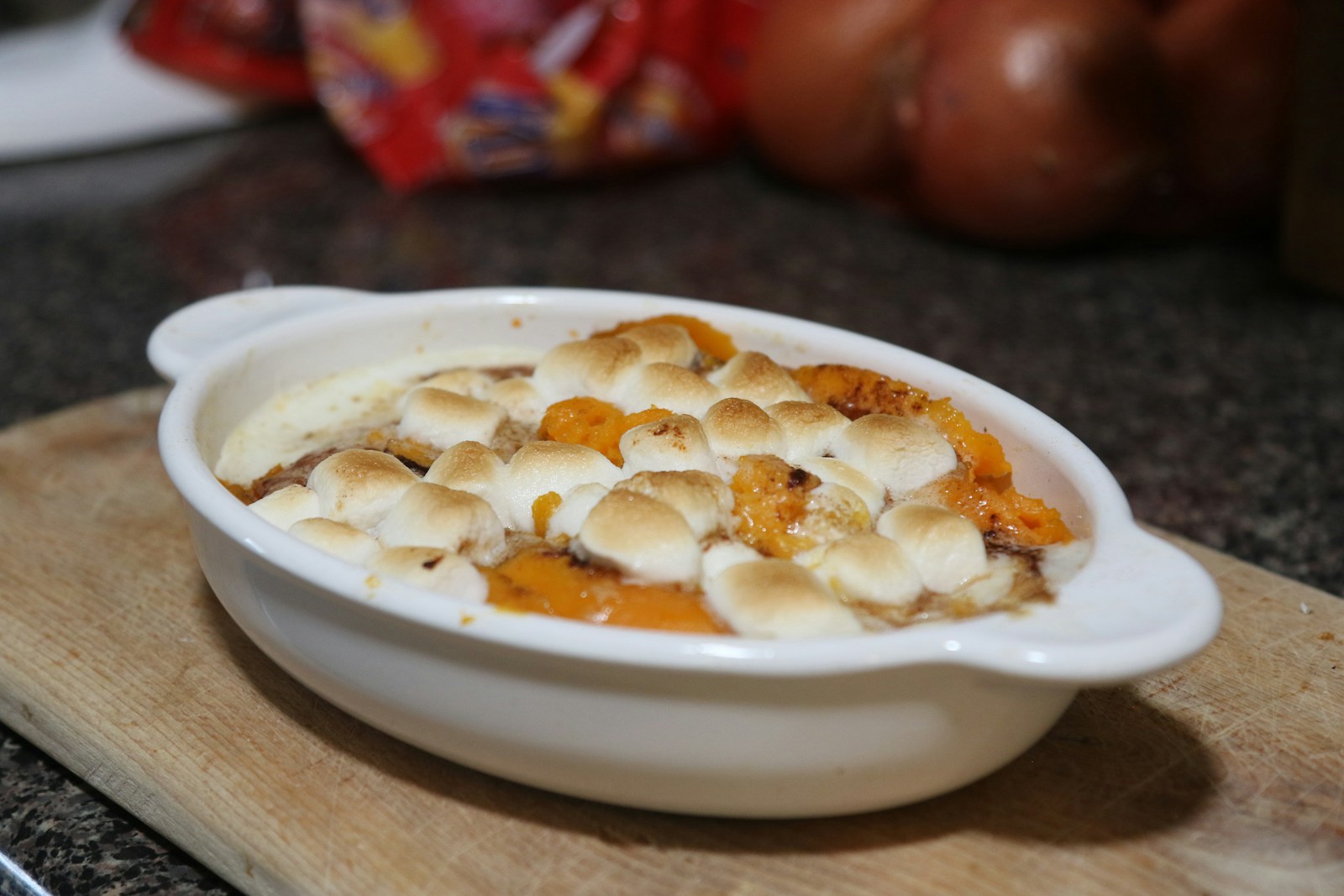 a bowl of food on a cutting board