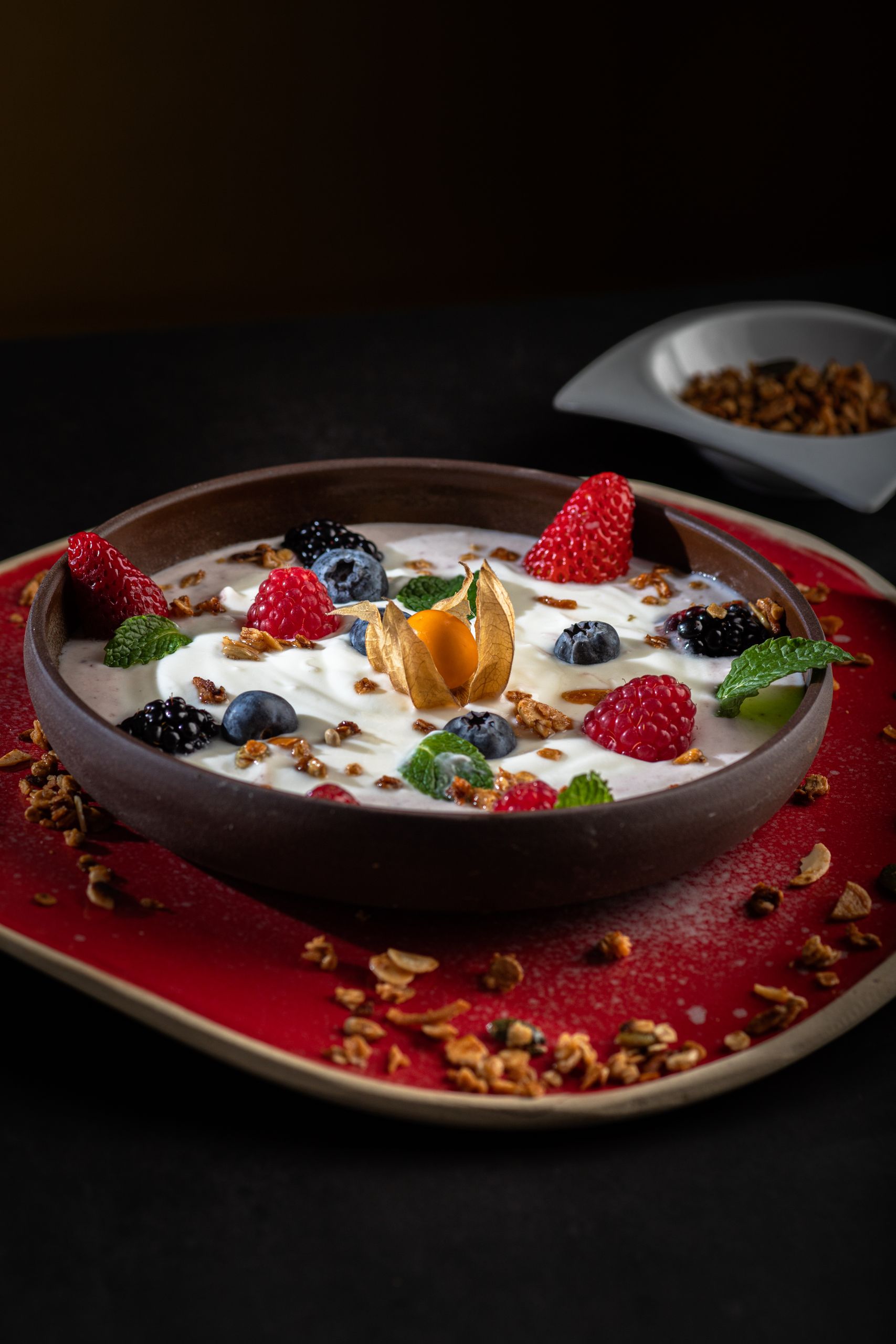Exquisite fruit and yogurt bowl with granola, perfect for a fresh breakfast.