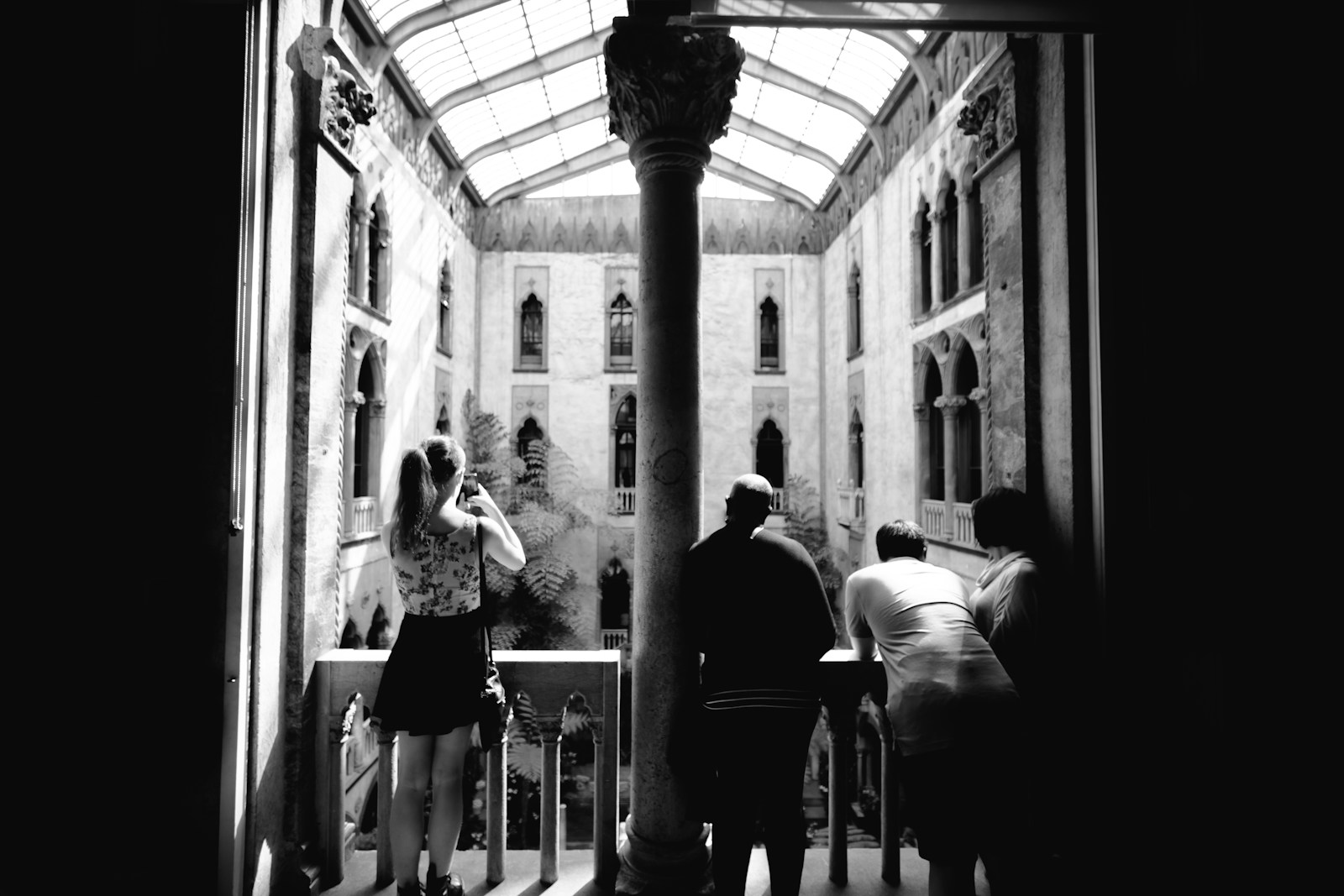 People looking out from a balcony in a grand building
