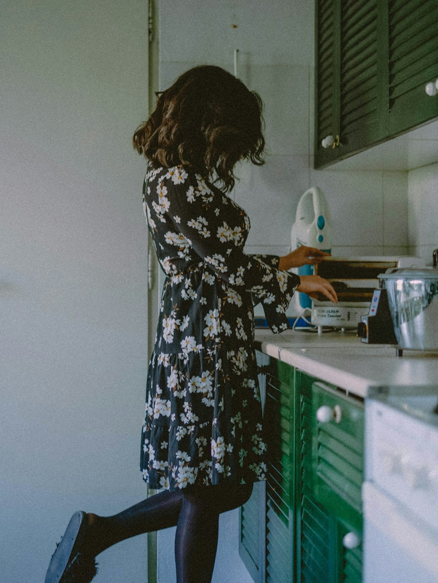 Woman in floral dress in a kitchen