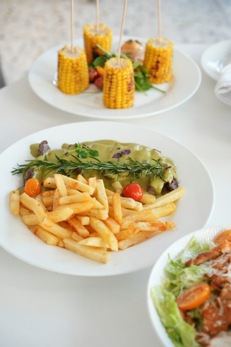 Delicious steak, fries, and corn on the cob