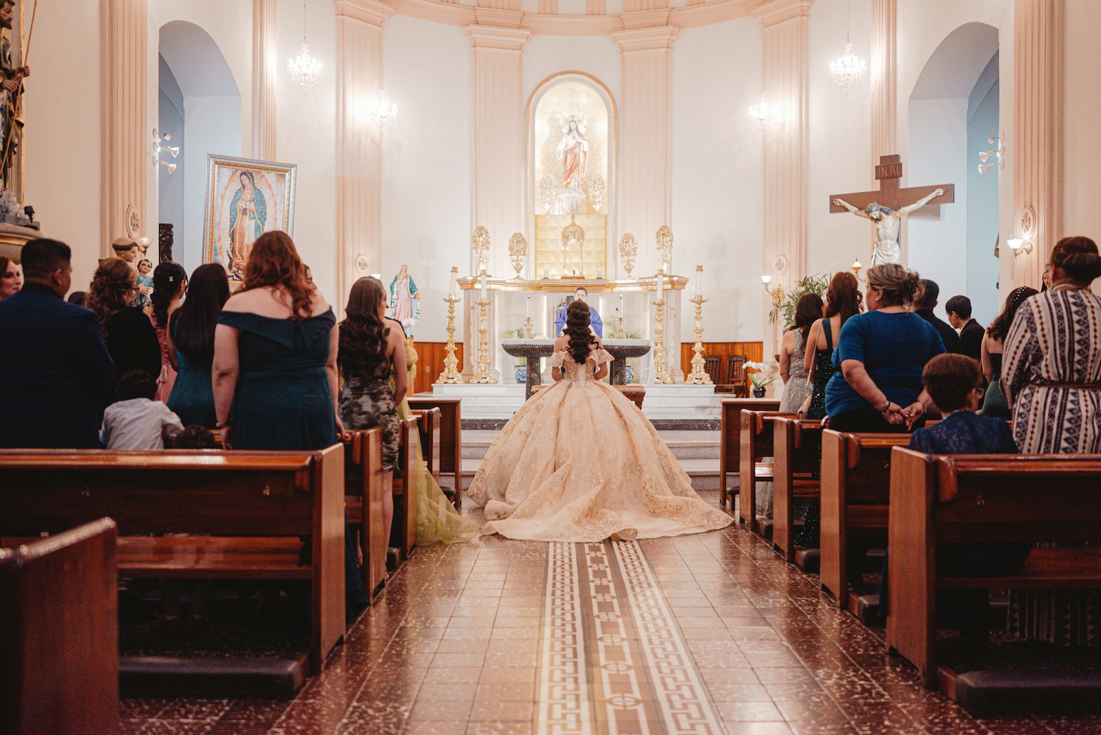 Bride in a church ceremony with guests seated
